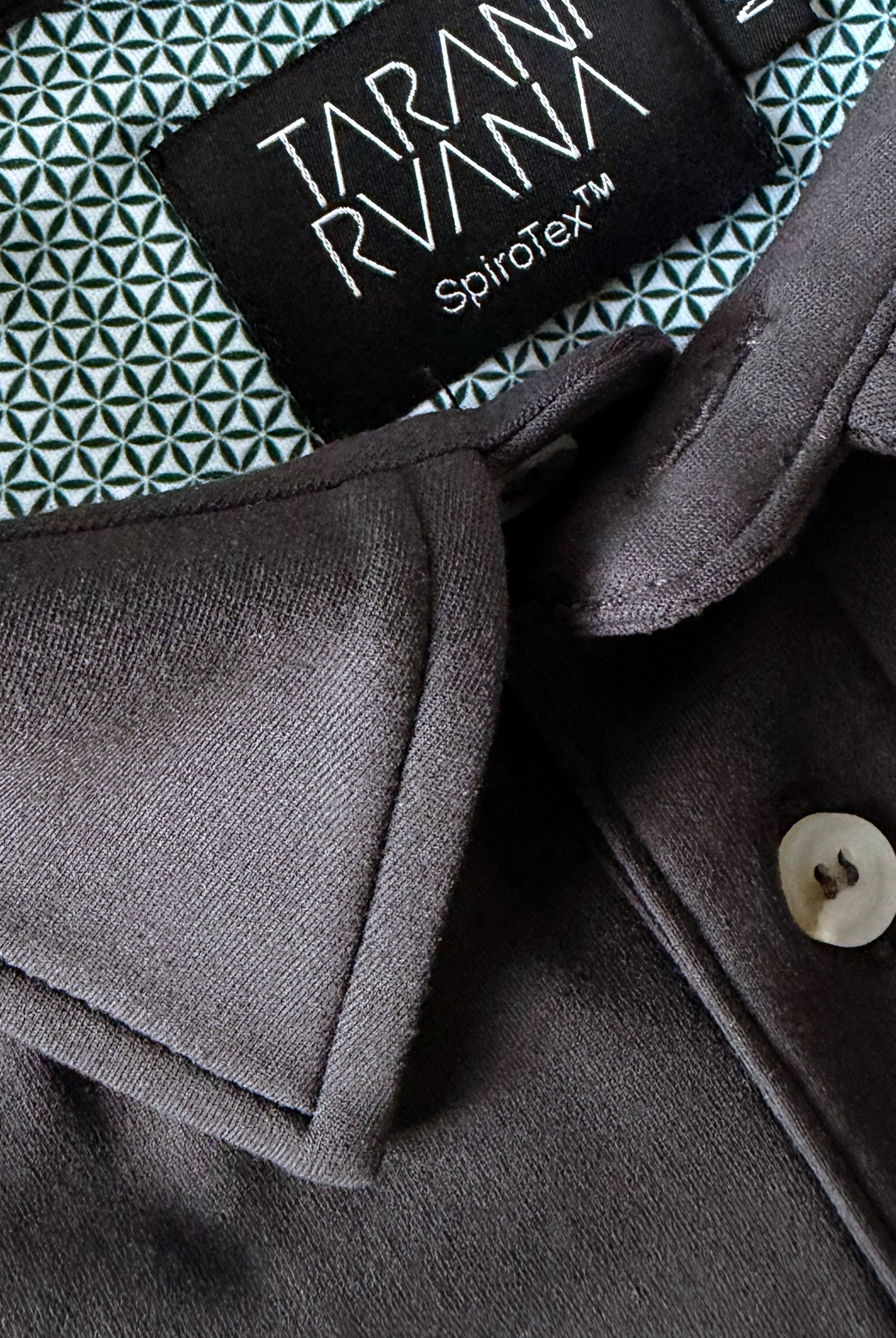 Close-up view of TARANIRVANA Aria Polo shirt collar in Phantom black, highlighting the premium placket button, minimalist tailored collar, and high-performance SpiroTex™ fabric with quick-dry, moisture-wicking, odor-resistant, and UPF 50+ sun protection.