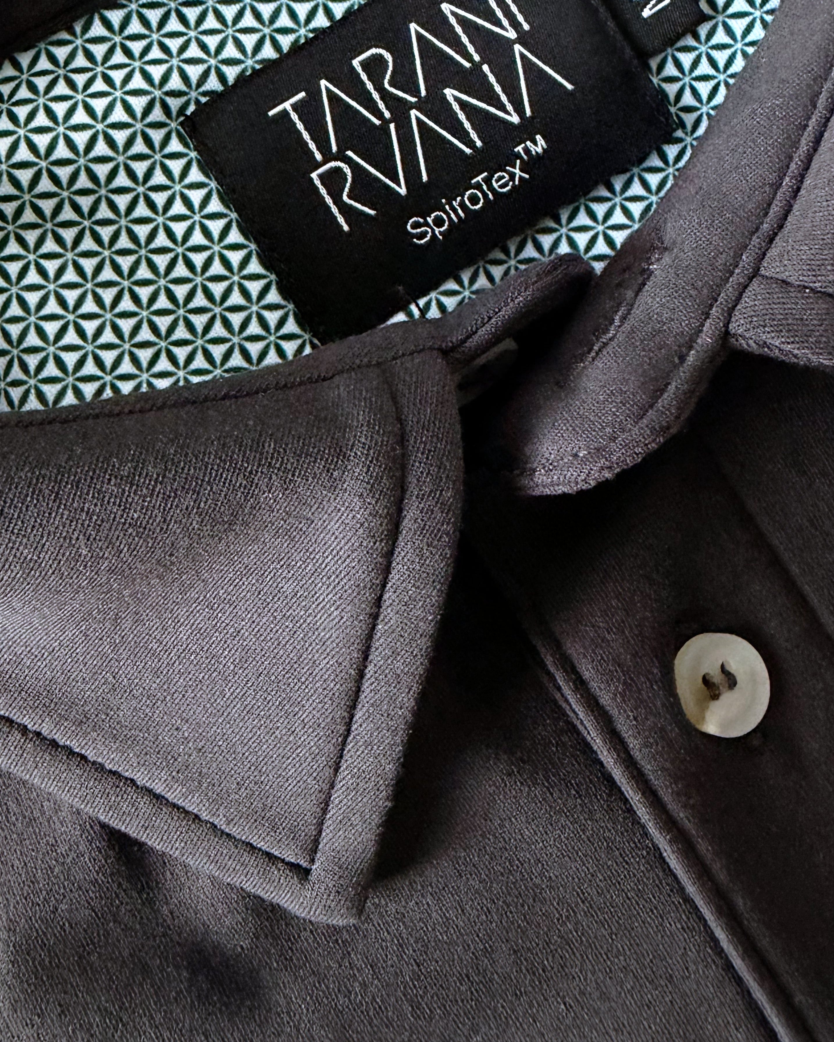 Close-up view of TARANIRVANA Aria Polo shirt collar in Phantom black, highlighting the premium placket button, minimalist tailored collar, and high-performance SpiroTex™ fabric with quick-dry, moisture-wicking, odor-resistant, and UPF 50+ sun protection.