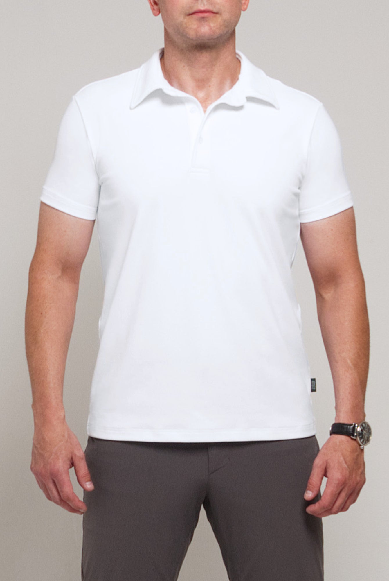 Cropped front view of a man wearing TARANIRVANA Aria Polo in Porcelain white, highlighting the clean fit and high-performance SpiroTex™ fabric with quick-dry, moisture-wicking, odor-resistant, and UPF 50+ sun protection.
