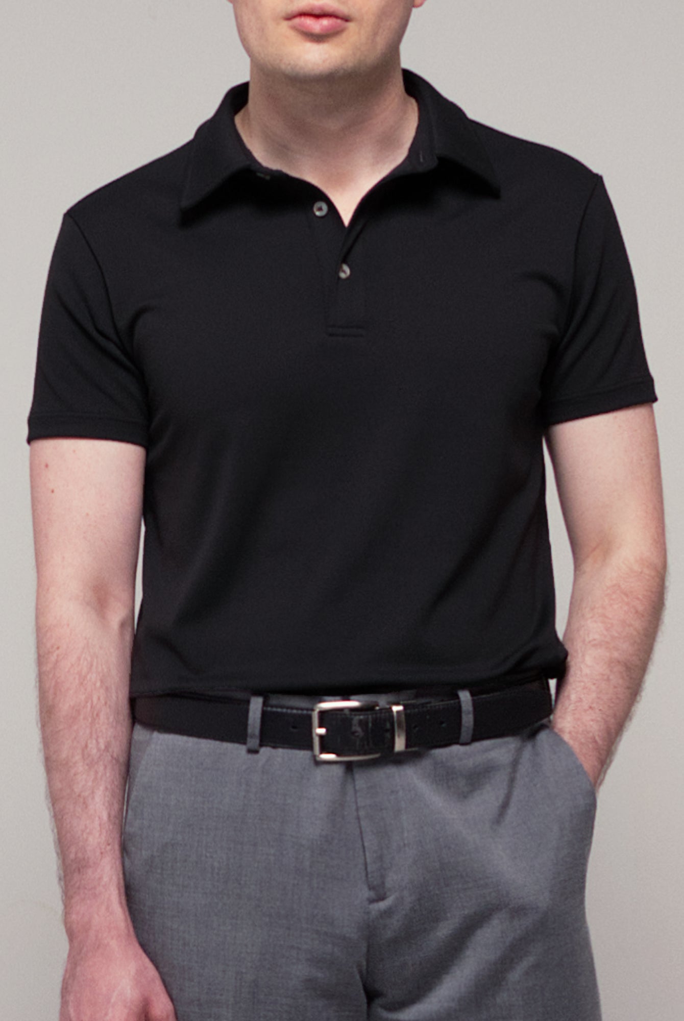 Close-up front view of TARANIRVANA Aria Polo in Phantom black, highlighting the premium placket details, minimalist collar, and high-performance SpiroTex™ fabric with quick-dry, moisture-wicking, odor-resistant, and UPF 50+ sun protection.