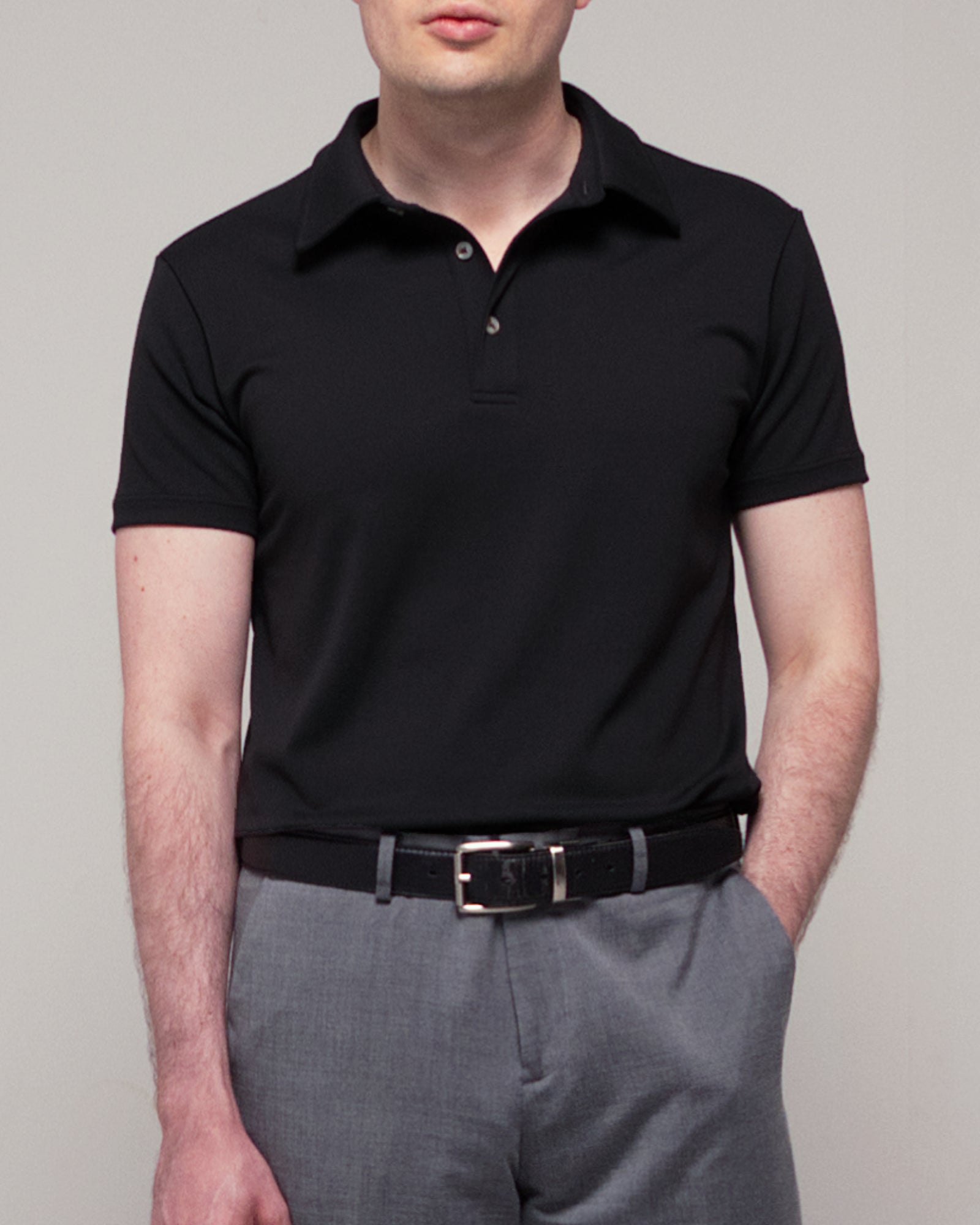 Close-up front view of TARANIRVANA Aria Polo in Phantom black, highlighting the premium placket details, minimalist collar, and high-performance SpiroTex™ fabric with quick-dry, moisture-wicking, odor-resistant, and UPF 50+ sun protection.