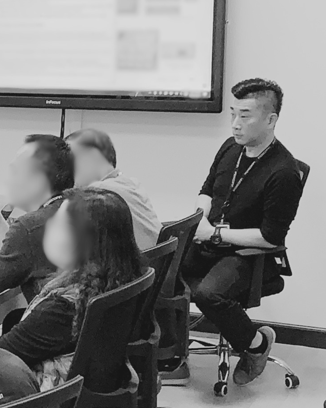 Nicolas Pang working as an Engineering Program Manager in a meeting