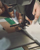 Close-up video of artisan hands precision sewing a garment, showcasing the premium craftsmanship and high-performance SpiroTex™ fabric engineered with quick-dry, moisture-wicking, odor-resistant, and UPF 50+ sun protection.