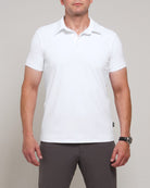 Cropped front view of a man wearing TARANIRVANA Aria Polo in Porcelain white, highlighting the clean fit and high-performance SpiroTex™ fabric with quick-dry, moisture-wicking, odor-resistant, and UPF 50+ sun protection.