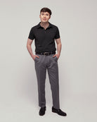 Front view of a man wearing TARANIRVANA Aria Polo in Phantom black, showcasing a sharp tailored business silhouette in high-performance SpiroTex™ fabric with quick-dry, moisture-wicking, odor-resistant, and UPF 50+ sun protection.