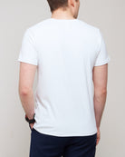 Cropped back view of a man wearing TARANIRVANA Essenza T-Shirt in Porcelain white, showcasing the clean shoulder tailoring and high-performance SpiroTex™ fabric with quick-dry, moisture-wicking, odor-resistant, and UPF 50+ sun protection.