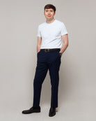 Full-length three-quarter view of a man wearing TARANIRVANA Essenza T-Shirt in Porcelain white, showcasing a refined smart casual silhouette in high-performance SpiroTex™ fabric with quick-dry, moisture-wicking, odor-resistant, and UPF 50+ sun protection.